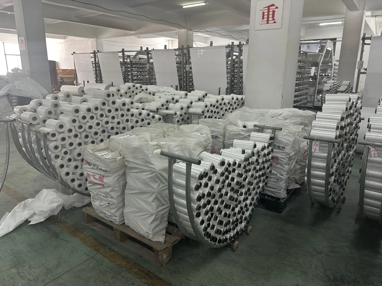 Bobbins and material rolls arranged on the Huaheng production floor
